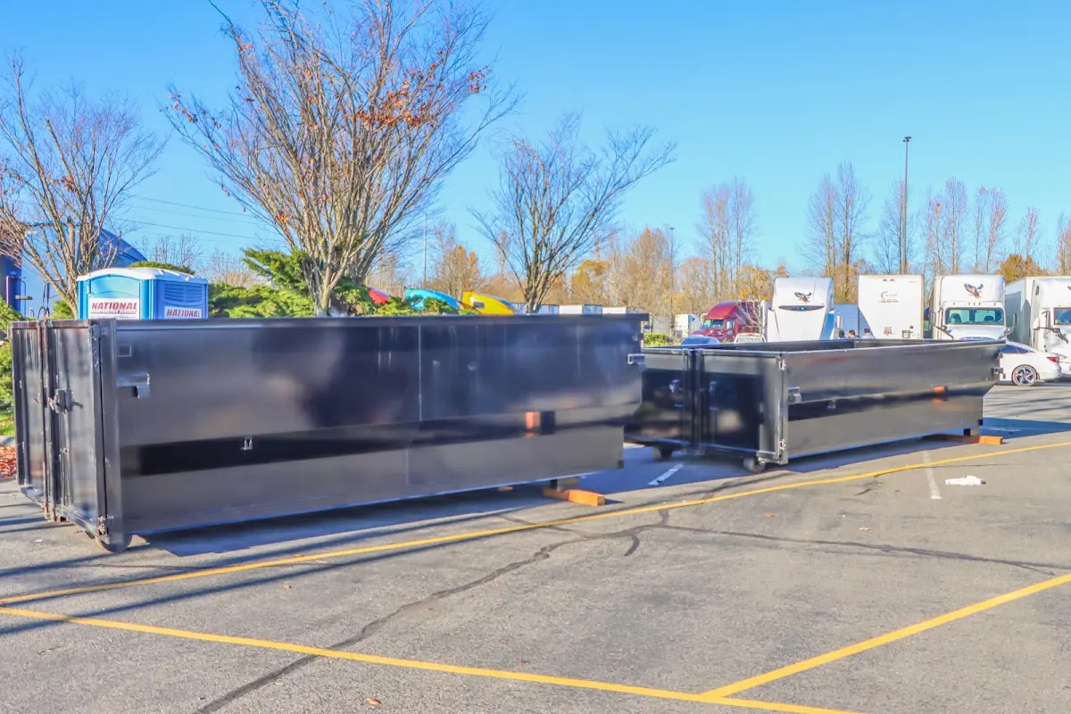 Professional dumpster rental service with roll-off container on residential driveway in University of California-Santa Barbara